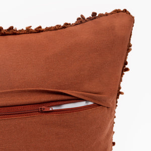 Capa de almofada decorativa no tamanho 45x45 cm na cor terracota confeccionada em algodão com texturas bordadas em alto relevo tufting com fechamento em zíper invisível, sinônimo de bem-estar e conforto térmico, ideal para momentos de descanso e relaxamento no lar.